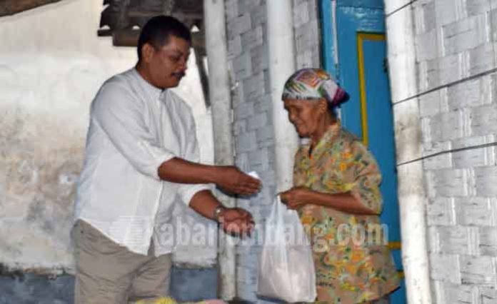 H Abdul Kodir saat memberikan paket sembako pada salah satu warga tak mampu di Desa Jatirejo, Diwek, Jombang