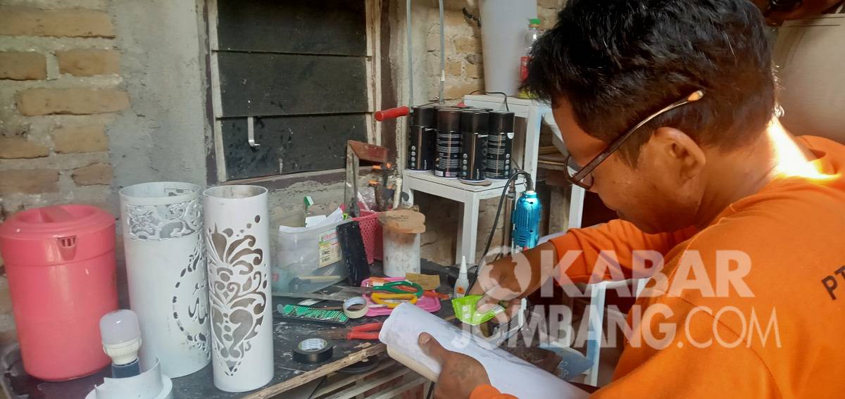 : Slamet Hariyanto (42) asal Desa Kedawung, Kecamatan Diwek, Kabupaten Jombang, saat membuat kerajinan lampu malam dengan bahan bekas paralon, Selasa (12/10/2021). KabarJombang.com/M Fa'iz Hasan/